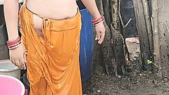Indian house wife bathing outside